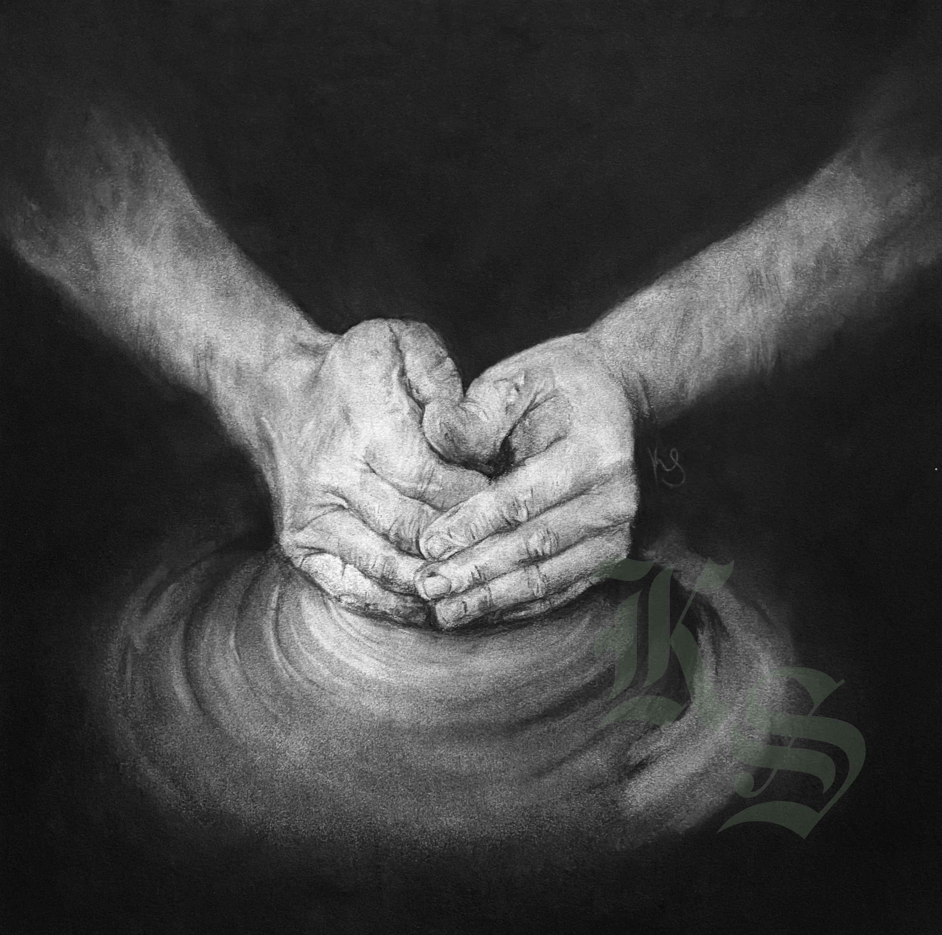 Charcoal drawing of two hands closed together around wet clay rising on a potter’s wheel, forearms lit against a black ground.